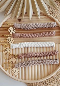 several different types of braided hair on a bamboo tray next to palm leaves and scissors