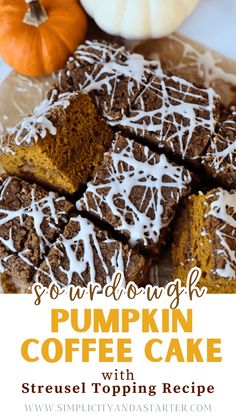 pumpkin coffee cake with drizzled white icing on top and two mini pumpkins in the background