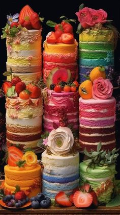 there are many different types of cakes on the table with strawberries and oranges