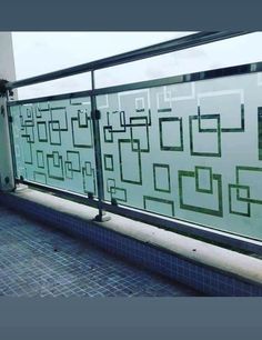 a glass balcony with tile flooring and railings on the side of a building