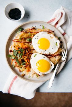 two fried eggs are on top of some rice