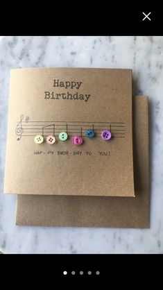 a birthday card with music notes and buttons