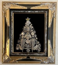 an ornate christmas tree framed in gold and black