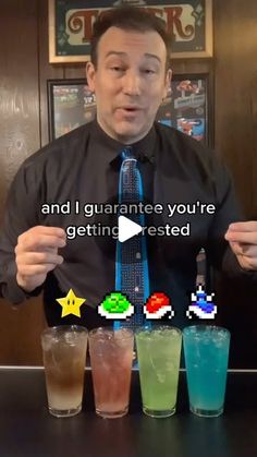 a man standing in front of four glasses filled with different colored drinks and the caption says, and i guarantee you're getting tested