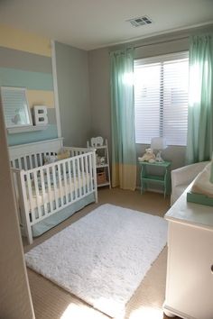 a baby's room with a white crib and green curtains