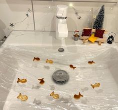 a bathtub filled with lots of little gold fish