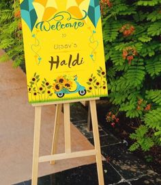 a welcome sign in front of some plants