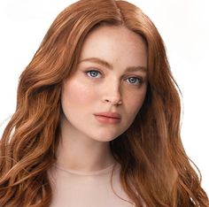 a woman with long red hair and blue eyes