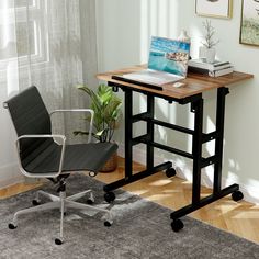 a desk with a laptop on it and a chair next to it in front of a window