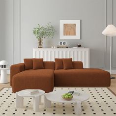 a living room with a couch, coffee table and lamp on the floor in front of a radiator