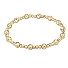 This bracelet is a classic gold beaded bracelet with alternating bead sizes. The larger bead size is a 4mm and the smaller bead size is a 2mm. Made with 4mm and 2mm, 14kt gold-filled beads Worry-free wear‚ which means sleep, shower and sweat in it Hand beaded on high performance elastic for a slight stretch to easily roll on and off your wrist Measures 6.75" Stacks well with all bracelets Gold Beaded Bracelet, Bead Sizes, Gold Bead Bracelets, Classic Gold, Bracelet Collection, Roll On, Gold Pearl, Gold Charm, Bracelet Stack