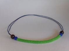 a green beaded necklace with blue beads