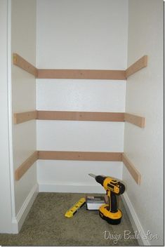 a room with some shelves and tools on the floor