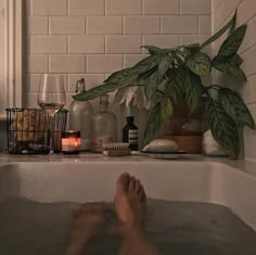 the person is relaxing in the bathtub with their feet up