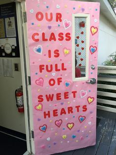 a pink door decorated with hearts and the words our class is full of sweet hearts