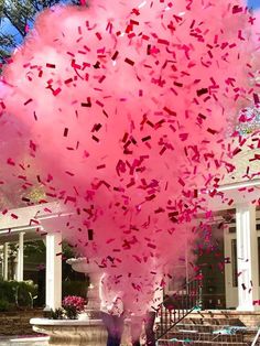 pink confetti is being thrown into the air