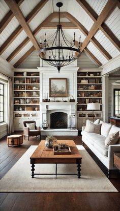 a living room filled with lots of furniture and a fire place under a chandelier