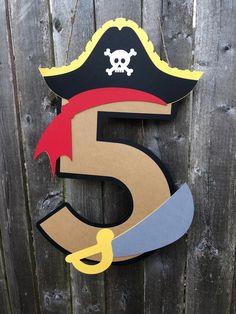 the number five is made out of cardboard and has a pirate hat on it