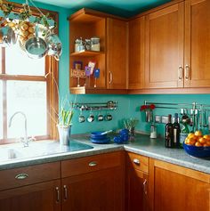 a kitchen with wooden cabinets and blue walls