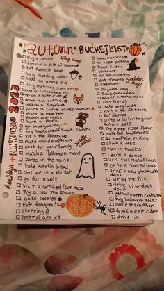 an autumn bucket list is shown on a bed