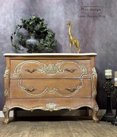 an old dresser with a giraffe figurine sitting on top of it