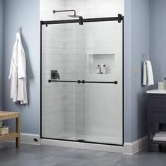 a bathroom with blue walls and tile flooring, including a walk in shower next to a sink