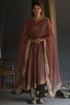 Featuring a blush peach asymmetrical kurta in chanderi zari base with floral boota and gold sequins hand embroidery. It is paired with matching pants, a mulmul slip, and an organza dupatta having mirror work.  FIT: Fitted at bust and waist. COMPOSITION: Chanderi zari, Mulmul, Organza. CARE: Dry clean only. Pink Anarkali, Ancient Techniques, Peach Fabric, Olive Green Pants, A Line Kurta, Hand Work Embroidery, Color Blush, Organza Dupatta, Embroidered Neckline