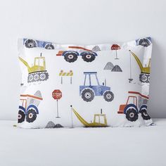 a pillow with construction vehicles on it