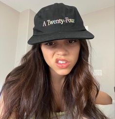 a woman wearing a black hat with the words a twenty four on it's brim