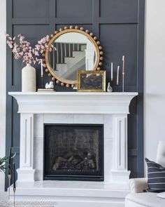 a fireplace with a mirror and candles on it