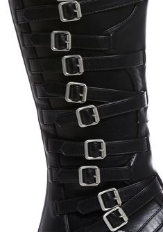 in a vegan leather construction. These knee high boots have decorative buckles on both sides, treaded soles, and back zipper closures. Gothic Moto Boots With Buckle Closure For Fall, Gothic Moto Boots With Buckle For Fall, Black Gothic Faux Leather Knee-high Boots, Gothic Black Faux Leather Knee-high Boots, Black Gothic Knee-high Faux Leather Boots, Punk Style Faux Leather Knee-high Boots, Edgy Knee-high Boots With Buckle Closure, Edgy Faux Leather Heeled Boots With Buckle Closure, Edgy Faux Leather Heeled Boots With Buckle