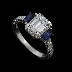 a diamond and sapphire ring on a black background