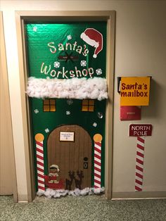 the door to santa's workshop is decorated with fake snow