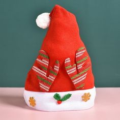 a red santa hat sitting on top of a table