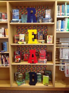 a book shelf with books and letters on it