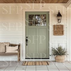 the front door of a house with a bench and potted plant