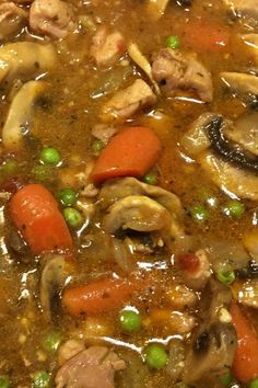 a stew with carrots, mushrooms and peas