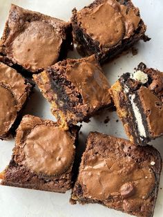 chocolate brownies cut into squares on a white surface