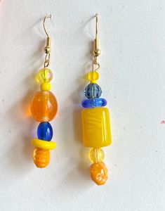 These new beach earrings are represented in two different ways. Each pair of earrings is different but should be worn together. A fun way of looking at jewelry and a fun way looking at life. #Beaddifferentinc Trendy Dangle Earrings For Vacation, Single Earring For Beach Summer, Summer Multicolor Hypoallergenic Earrings, Trendy Single Earring For Beach Jewelry, Trendy Single Earring For Beach, Summer Single Yellow Earring, Summer Beach Yellow Jewelry, Single Earring For Everyday Summer Wear, Multicolor Fun Earrings For Vacation