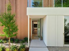 an entrance to a modern home with wood siding