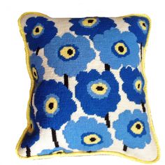 a blue and yellow pillow with flowers on it