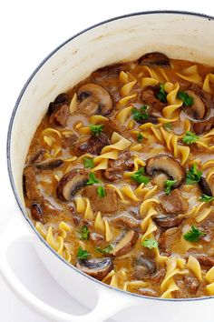 a large pot filled with pasta and mushrooms