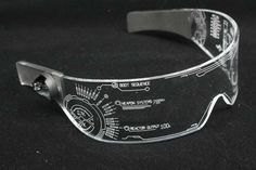 a pair of glasses that are sitting on a black surface with words etched in them