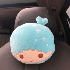 a stuffed toy is sitting in the back seat of a car with its head resting on it's pillow