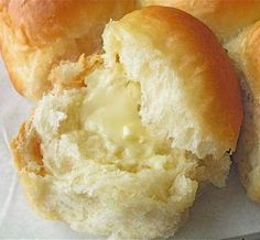 some bread rolls with butter on top of them