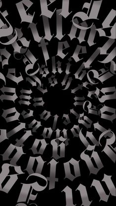 an abstract black and white photo with the letters in it's center, surrounded by smaller silver letters