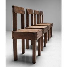 three wooden chairs sitting next to each other