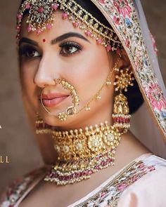 an image of a woman with jewelry on her face and in the background, she is wearing