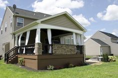 a house with a covered porch in the front yard