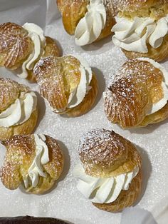 several pastries with white icing and powdered sugar on top